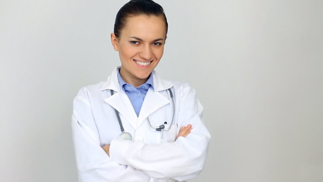 Attractive happy female doctor with crossed hands portrait