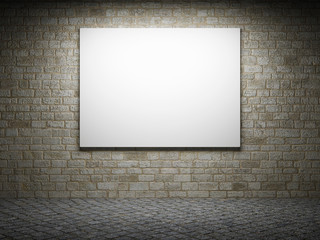 Blank billboard on a brick wall at night.