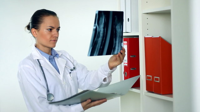 Female doctor looking at xray photographs