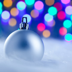 Christmas silver bauble in blurred lights