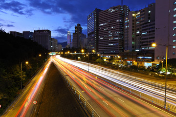 Fototapeta na wymiar light trails on modern city at night