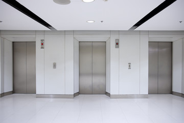 Three elevator doors in office building