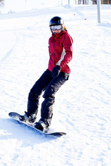 Fototapeta na wymiar Female snowboarder on the snowhill