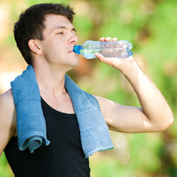 Man drinking water after fitness