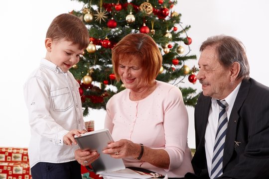 Small boy with grandparents at christmas