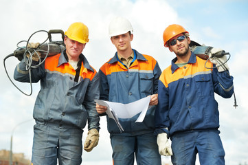 construction workers with power tools