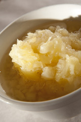 Crushed pineapple in a bowl as used in cooking