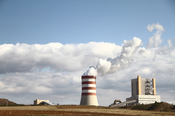 Power plant with smoking chimney