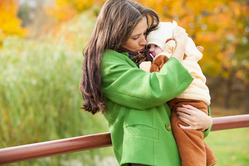 Fototapeta premium young mother put little child to him