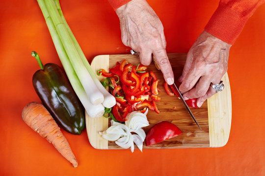 Senior Woman's Hands Cutting Vegetables