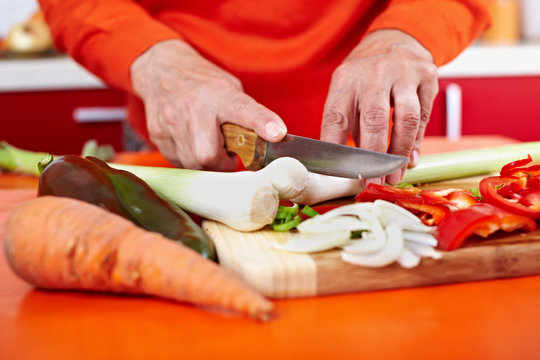 Senior Woman's Hands Cutting Vegetables