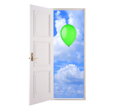 Open door in blue sky and green hot air balloon