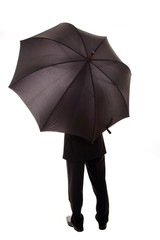Business man hold an umbrella standing back, isolated over white