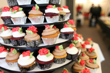 Various gourmet cupcakes on display tray.