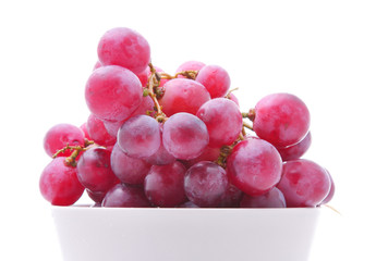 Image of red grape in bowl isolated on white