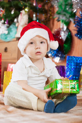 boy sits with  Christmas gift