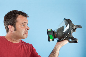 man holding a gas mask