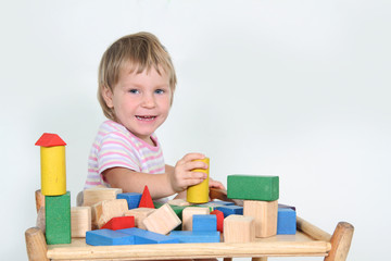 cute child playing with building blocks isolated over white