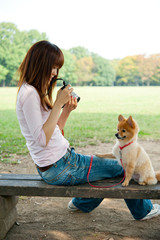 attractive asian woman with dog in the park