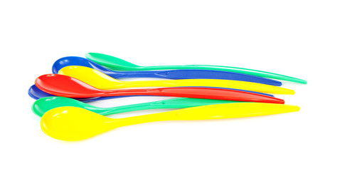 colorful plastic spoons over white background