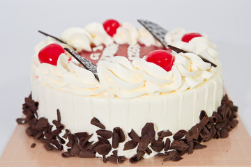 cake and cherries on top .