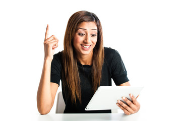 Happy young indian teen girl on tablet computer