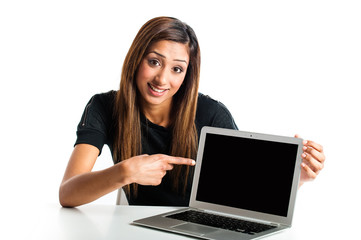 Young Asian woman pointing to laptop.