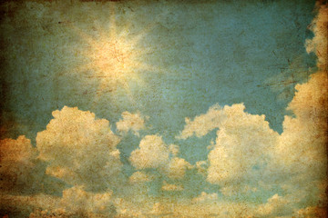 Grunge image of sky with clouds and sun