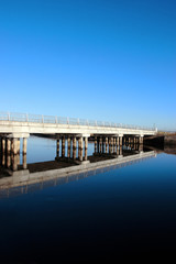 cashen road bridge over cold river reflected