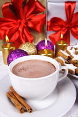 Hot chocolate with cinnamon sticks and cookies