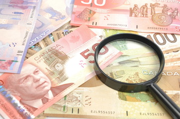 Magnifying glass on money background