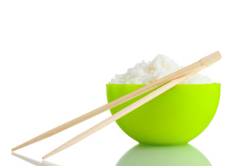 Green bowl of cooked rice and chopsticks isolated on white