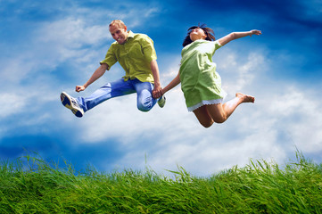 Fun couple in jump on the outdoor background
