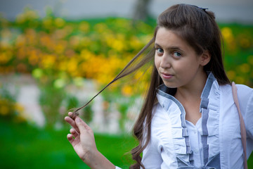 teen with hair in hand