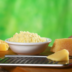 Grated Italian hard cheese with rasp in front