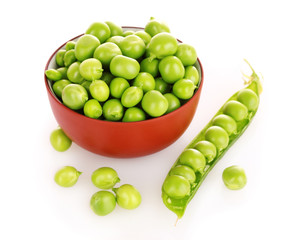 green peas in a red bowl, isolated on white