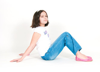 The girl sits on a white background