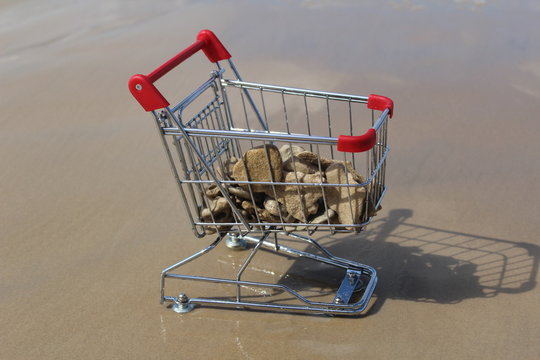 Retail cart stuck at sea water with stones inside