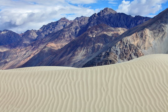 Sand dunes against the Himalayas background