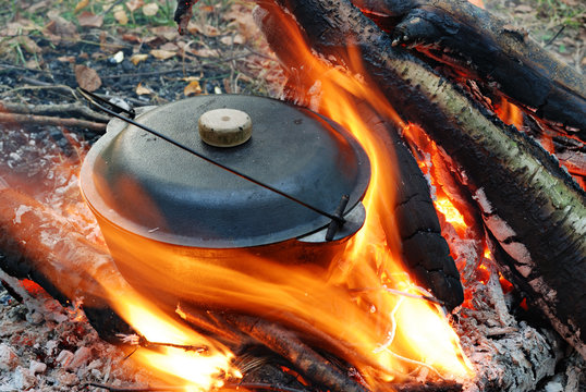 camping fire and food in pot