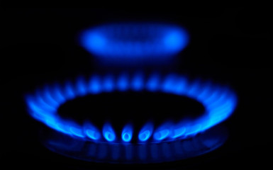 Blue flames of gas stove in the dark