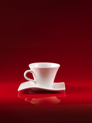 white cup of coffee on red background