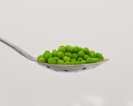 Green Peas On Large Serving Spoon