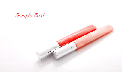 two tubes of lips gross on white background