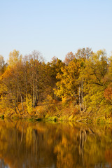 Colorful autumn trees fortress at the river front