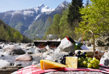 Red wine, cheese and grapes.Verzasca valley, Switzerland