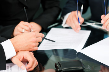 Business meeting with work on contract
