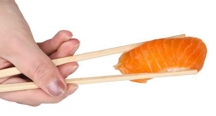 Chopsticks with salmon sushi