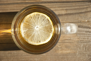 cup of tea with lemon on wooden table