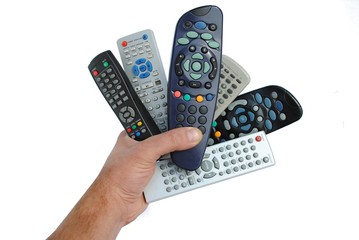 man hand holds six remote control, isolated on white - obrazy, fototapety, plakaty